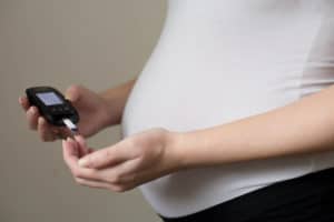 Diabetes test. Pregnant women checking sugar level with glucometer.Gestational diabetes.
