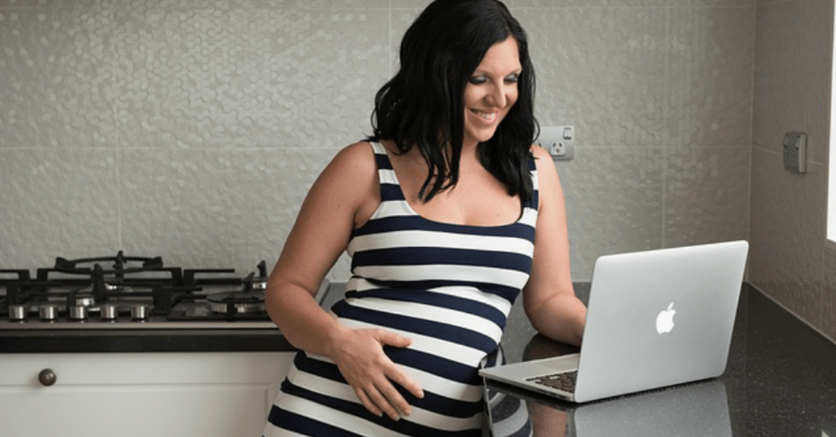 woman third trimester pregnancy computer